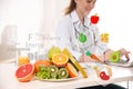 Nutritionist`s recommendations. Doctor with healthy products at table