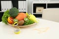 Nutritionist`s workplace with fruits, vegetables, measuring tape and body fat caliper on table