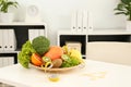 Nutritionist`s workplace with fruits, vegetables, measuring tape and body fat caliper