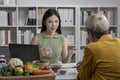 Nutritionist with woman client talking about meal plan and healthy products during a medical consultation Royalty Free Stock Photo