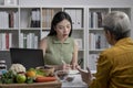 Nutritionist with woman client talking about meal plan and healthy products during a medical consultation Royalty Free Stock Photo