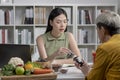 Nutritionist with woman client talking about meal plan and healthy products during a medical consultation Royalty Free Stock Photo