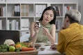 Nutritionist with woman client talking about meal plan and healthy products during a medical consultation in the office. Royalty Free Stock Photo