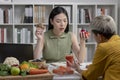 Nutritionist with woman client talking about meal plan and healthy products during a medical consultation in the office. Royalty Free Stock Photo