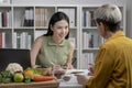 Nutritionist with woman client talking about meal plan and healthy products during a medical consultation Royalty Free Stock Photo