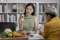 Nutritionist with woman client talking about meal plan and healthy products during a medical consultation Royalty Free Stock Photo