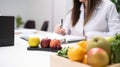 Nutritionist working at desk in office, closeup view, generative ai