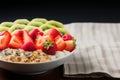 A nutritious breakfast featuring yogurt, muesli, kiwi, strawberries, and banana