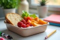 A nutritious and delicious midday meal featuring fresh strawberries, apricots, and a slice of bread, presented in a light beige Royalty Free Stock Photo