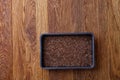 Nutritious flaxseed on baking tray over wooden background, selective focus, shallow depth of field.