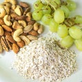 Nutritious food groups of grapes, mixed nuts and oats in next to Royalty Free Stock Photo