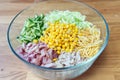 Nutritious vegetable salad with smoked chicken in a clear bowl. Ingredients are folded neatly not heremeshed