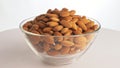 Nuts almond rotate are on a table in a plate. Snack in transparent dish on an isolated white background are spinning Royalty Free Stock Photo