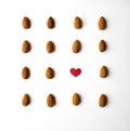 Nuts, almond, tasty and healthy food with lots of vitamins. Almond nuts placed in pattern with red paper heart. Royalty Free Stock Photo