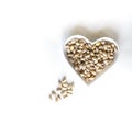 Nuts arranged in heart on background. Healthy Food image close up pistachios on the cup plate. Love Texture on white grey table