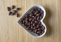 Nuts arranged in heart shape on background. Food image close up candy, chocolate milk, extra dark almond nuts. Love Texture