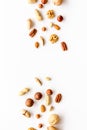 Nuts background - with almond, macadamia, walnut, hazelnut, pecans - on white table top-down copy space