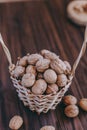 Nuts in a basket on a wooden background