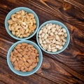 Nuts on wood textured surface. Mix of pistachios, cashews, almonds Royalty Free Stock Photo