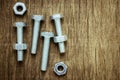 Nuts and bolts on abandoned wood desk.