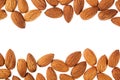 Nuts border of almonds on white background. Pile of selected almond close-up. Royalty Free Stock Photo