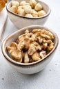 Nuts in bowl, on white stone table background Royalty Free Stock Photo