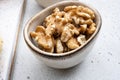 Nuts in bowl, on white stone table background Royalty Free Stock Photo