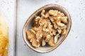 Nuts in bowl, on white stone table background, top view flat lay Royalty Free Stock Photo