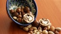 Nuts in bowl on wooden background, top view with copyspace. Royalty Free Stock Photo