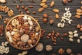 Nuts in bowls. Walnuts, pistachios, pecans, macadamia, almonds and other. Healthy food snacks mix on wooden background, top view Royalty Free Stock Photo