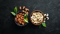 Nuts Cashew and Almond in a bowl on a black background. Top view. Royalty Free Stock Photo