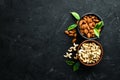 Nuts Cashew and Almond in a bowl on a black background. Top view. Royalty Free Stock Photo