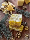 Nuts and cheese and honey, snack for wine, Christmas and goodies, honey honeycombs, spruce and cheese branch, spruce and honey hon Royalty Free Stock Photo