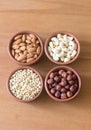 Nuts in clay bowls on a wooden table