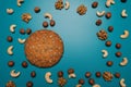 Nuts and cookies with empty place for text. Studio image. Homemade cookies with set nuts on a blue background.