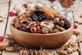 Nuts and dried fruit mix, healthy and wholesome food. Vintage wooden background, selective focus Royalty Free Stock Photo