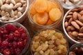 Nuts and dried fruits assortment in jars and bowls. Royalty Free Stock Photo