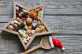 Nuts and dried fruits mix for Christmas with spoon and Santa`s hat on wooden boards Royalty Free Stock Photo