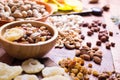 Nuts and dry fruit, in bowls, on boards