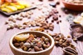 Nuts and dry fruit, in bowls, on boards