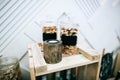 Nuts in glass jars on a wedding buffet table snacks