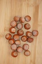 Nuts of the hazelnut variety are scattered on the surface. Royalty Free Stock Photo