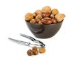 Nuts mix in brown plate and silver nutcracker Royalty Free Stock Photo