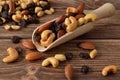 Nuts mixture of almond, cashew, peanut and raisin scattered from wooden spatula Royalty Free Stock Photo