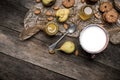 Nuts pears Cookies and milk on wooden table