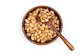 Nuts pistachios in a wooden spoon and a brown wooden plate on a white background. Top view