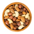 Nuts and raisins in wooden bowl over white Royalty Free Stock Photo