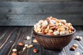 Nuts set in bowl almonds, pistachios, cashews, peanuts, vintage wooden background Royalty Free Stock Photo