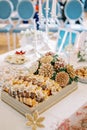 Nuts in the shape of flowers on a stand next to the cakes are on the table. Tradition of Sofreh Aghd Royalty Free Stock Photo