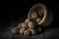 Nuts spilled from a wooden bowl on a black background Royalty Free Stock Photo